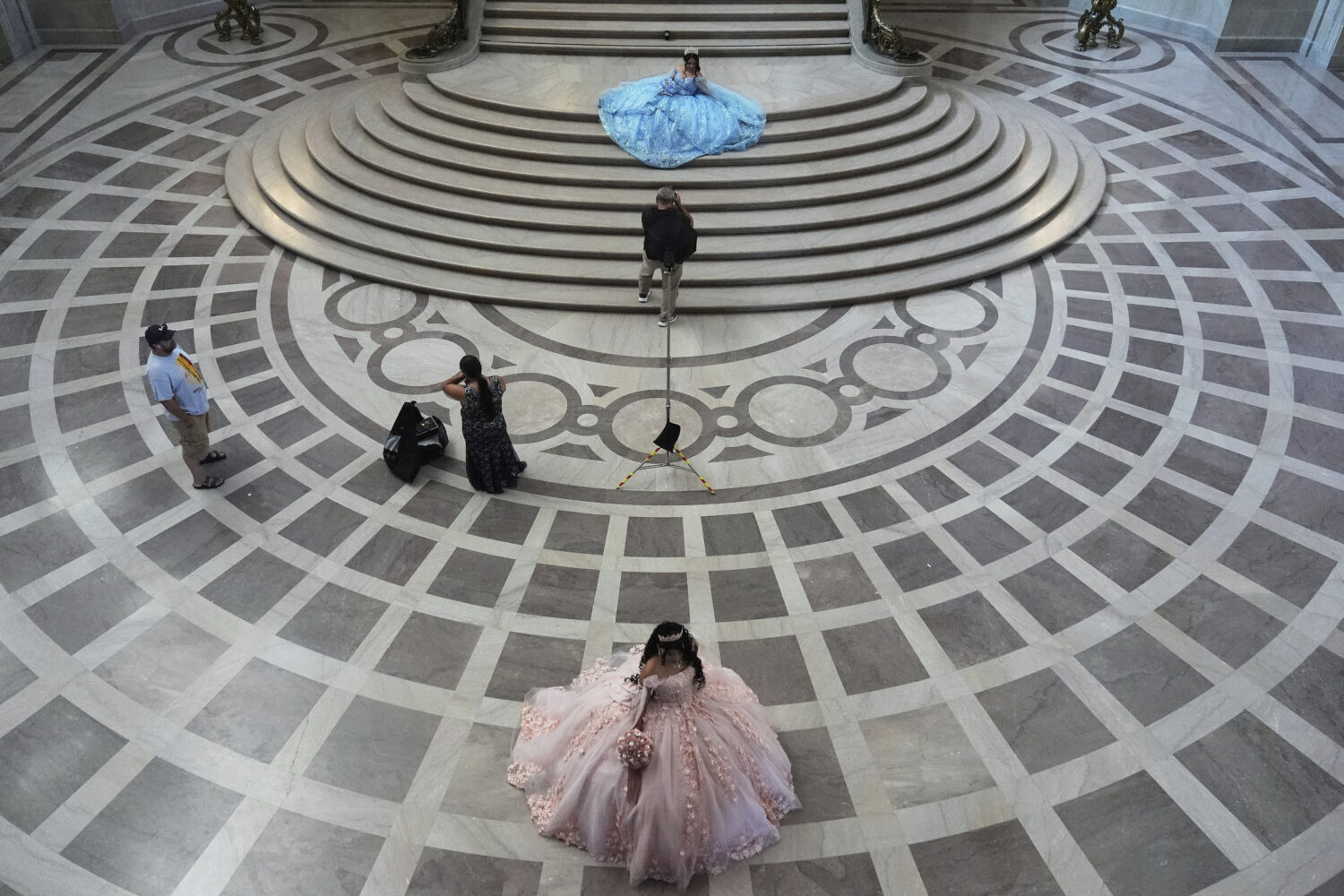 Abbie Gonzalez, top, poses for photographer Miguel Plascencia as she has her quinceañera portrait ...