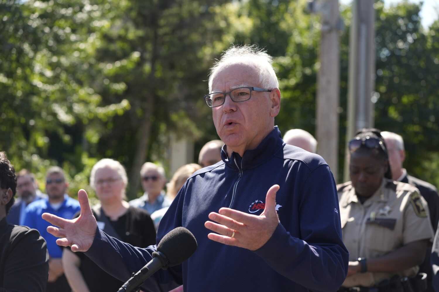 Minnesota Gov. Tim Walz speaks outside the Annunciation Catholic School following a shooting Wednes...