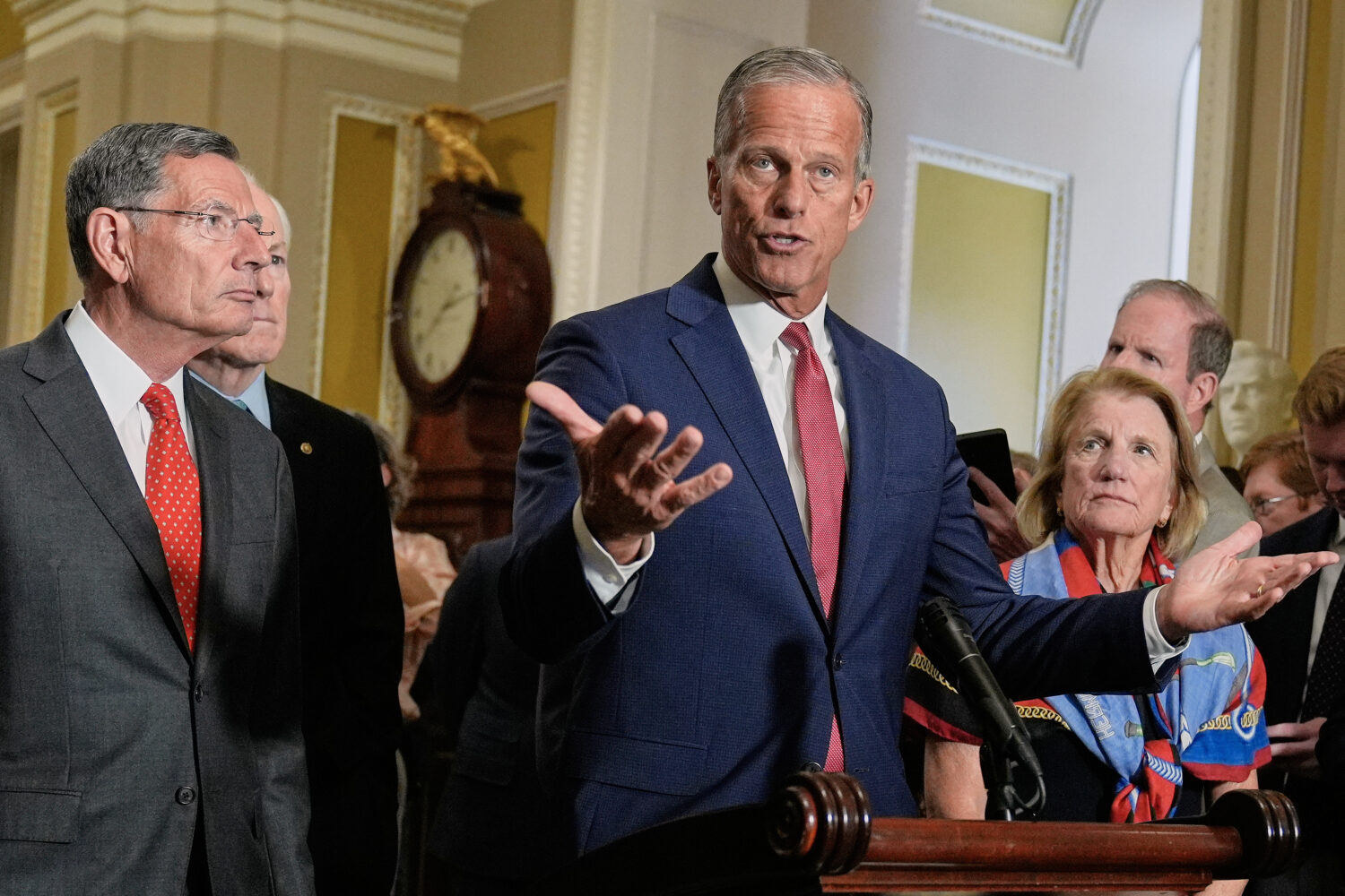 Senate Majority Leader John Thune, R-S.D., center, speaks during a news conference after a policy l...
