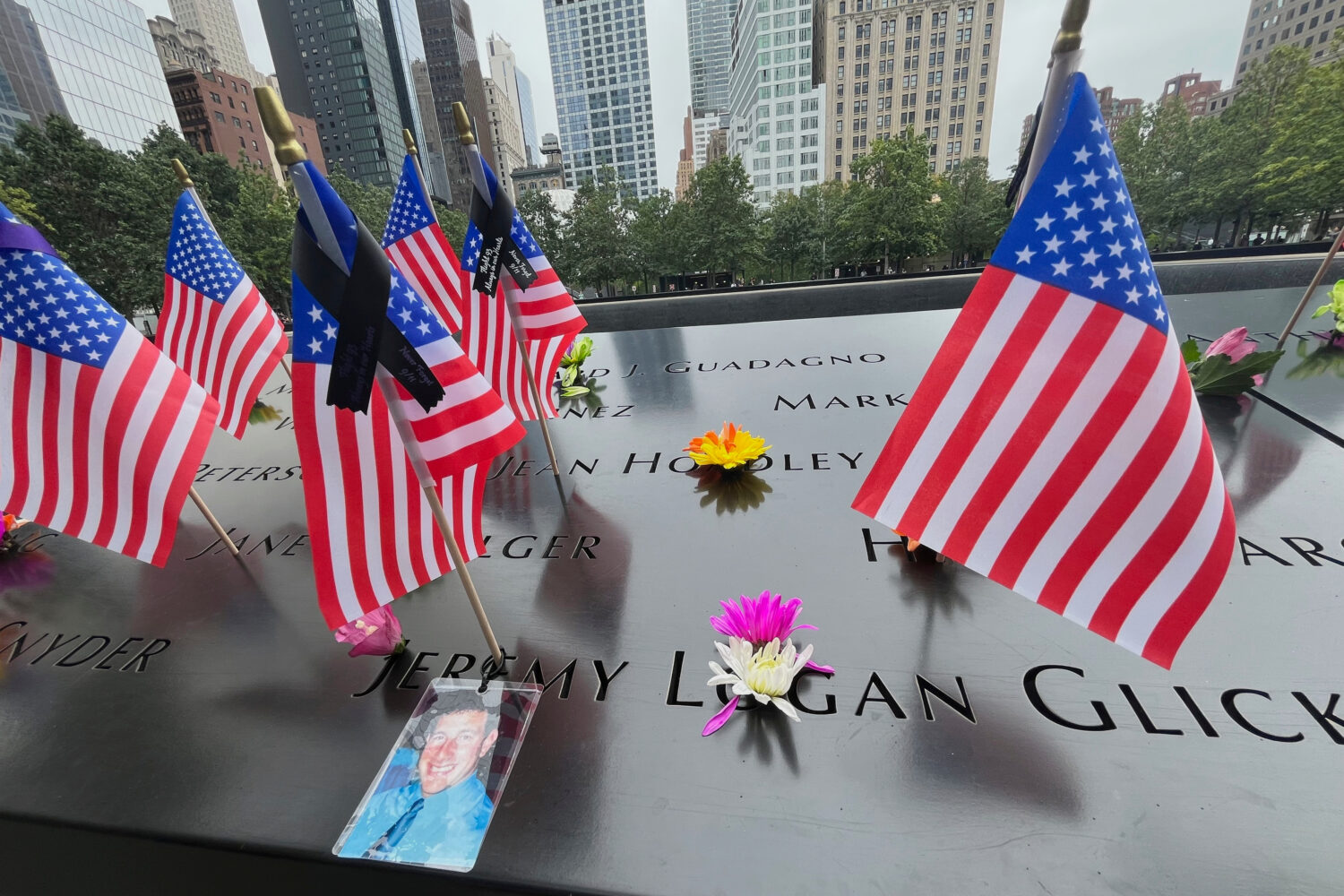 Flags and flowers are placed in the inscribed names at the National September 11 Memorial in New Yo...