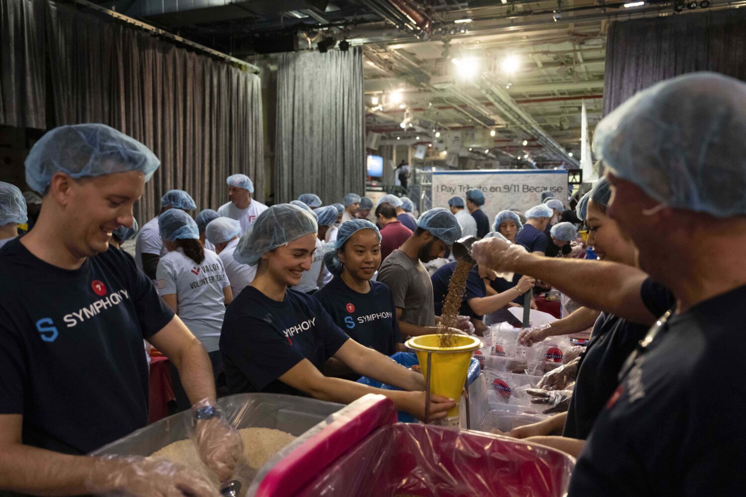 Volunteers work during the "NYC Meal Pack For 9/11 Day" at the Intrepid Sea, Air & Space Museum, We...