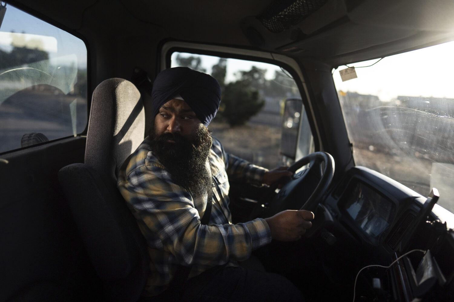 Sikh truck driver Prahb Singh maneuvers his truck at a gas station in Fontana, Calif., Wednesday, S...