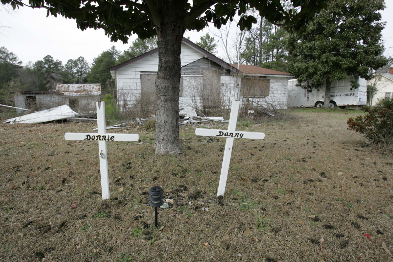 FILE- Two crosses still stand in the front yard Tuesday, Jan. 23, 2007, where Sheriff's Sgt. Danny ...