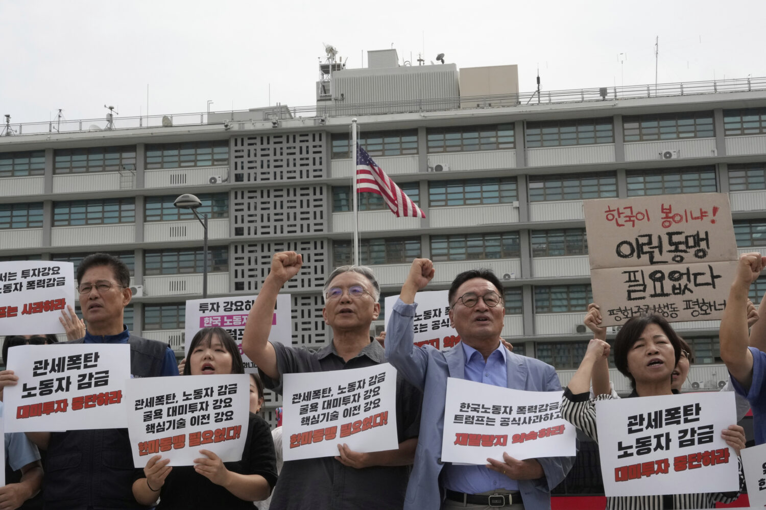 Protesters stage a rally against the detention of South Korean workers during an immigration raid i...