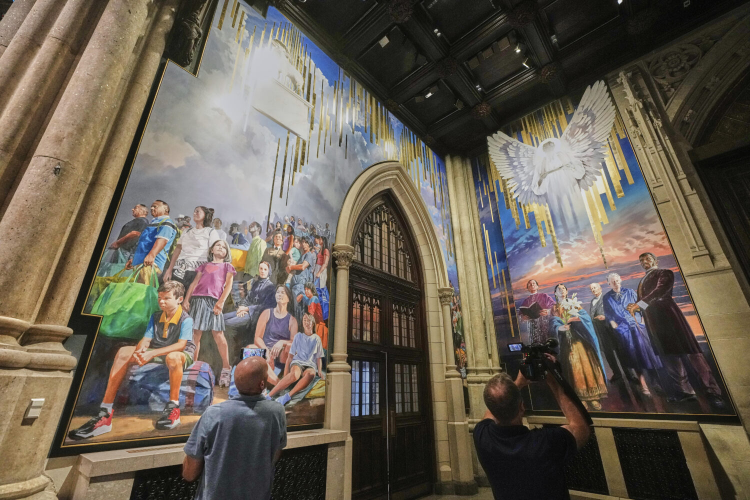 Photographers work during a media preview of the 25-foot-high mural by artist Adam Cvijanovic, the ...