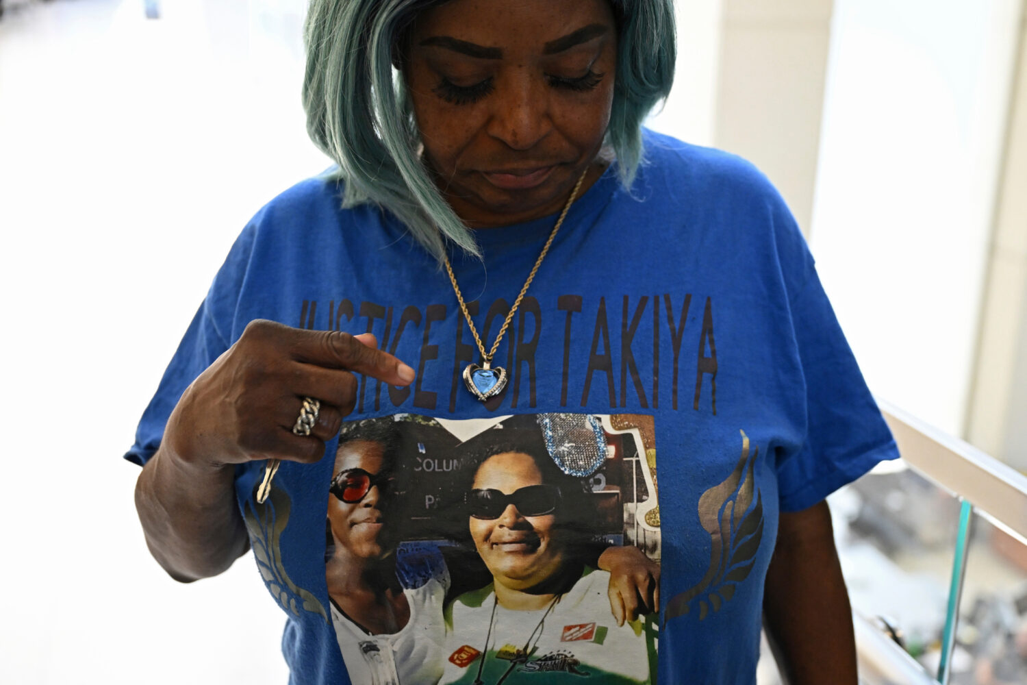FILE - Nadine Young, grandmother of Ta'Kiya Young, shows her shirt to reporters after arraignment p...