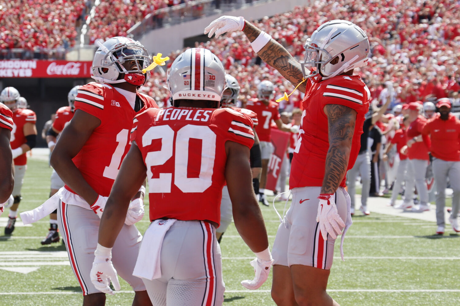 Ohio State receiver Carnell Tate, left, celebrates his touchdown against Texas during the second ha...