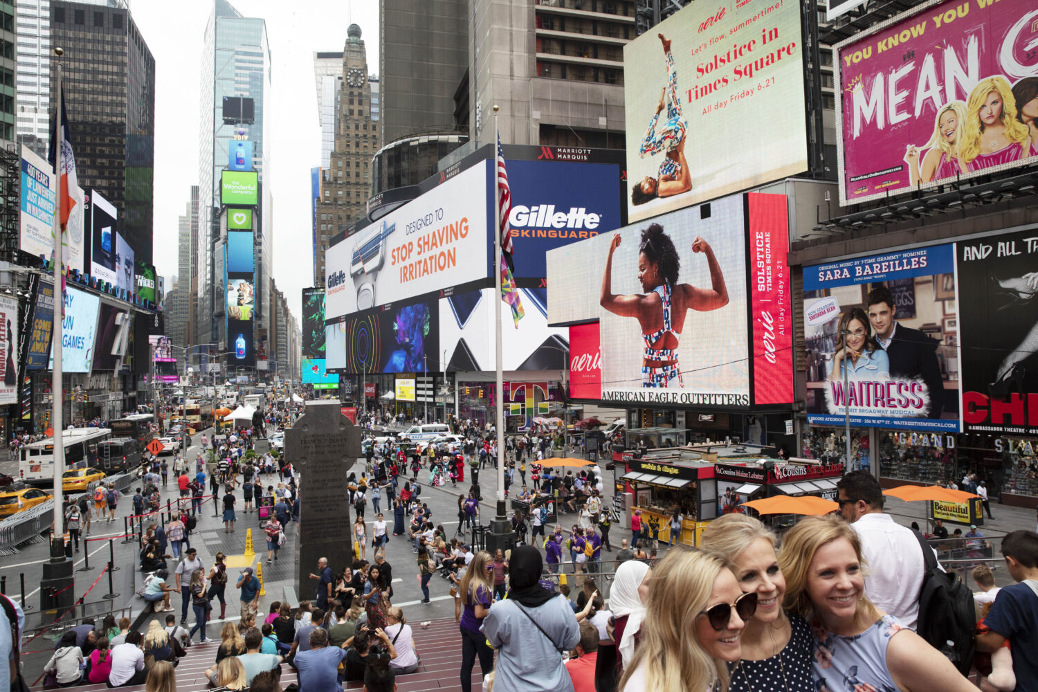 FILE - In this June 20, 2019, file photo, tourists visit Times Square in New York. (AP Photo/Mark L...