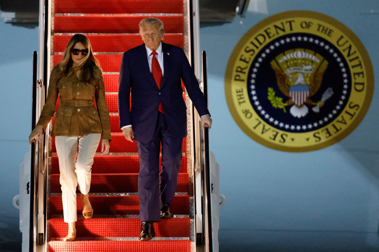President Donald Trump and first lady Melania Trump disembark Air Force One at Joint Base Andrews, ...