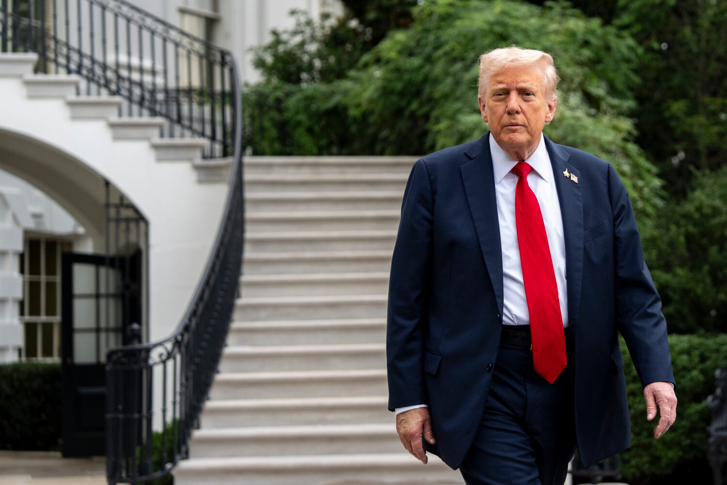 President Donald Trump walks to speak with reporters before departing on Marine One from the South ...