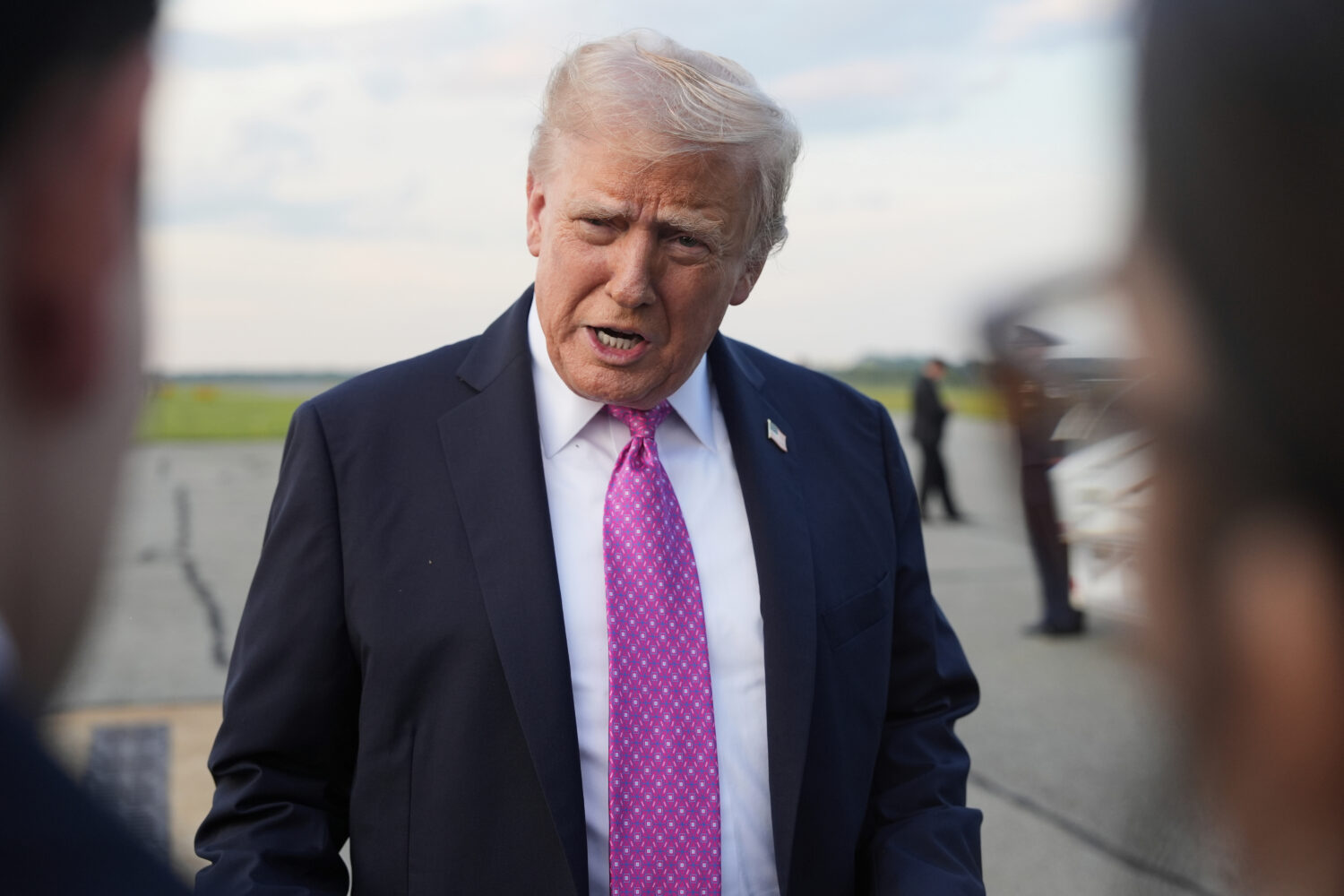 President Donald Trump speaks with reporters before boarding Air Force One at Morristown Airport, S...
