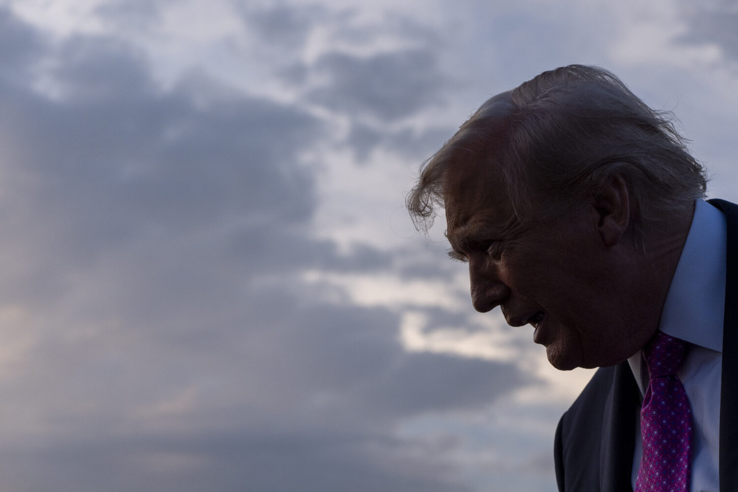 President Donald Trump speaks with reporters before he departs on Air Force One at Morristown Airpo...