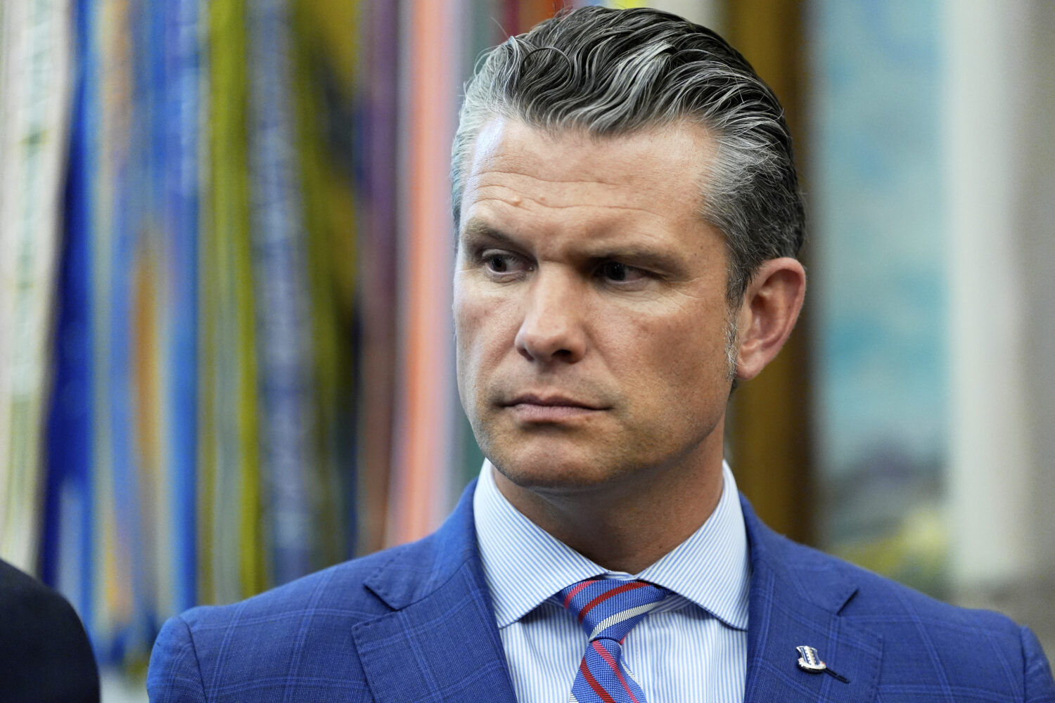 Defense Secretary Pete Hegseth listens as President Donald Trump speaks in the Oval Office of the W...