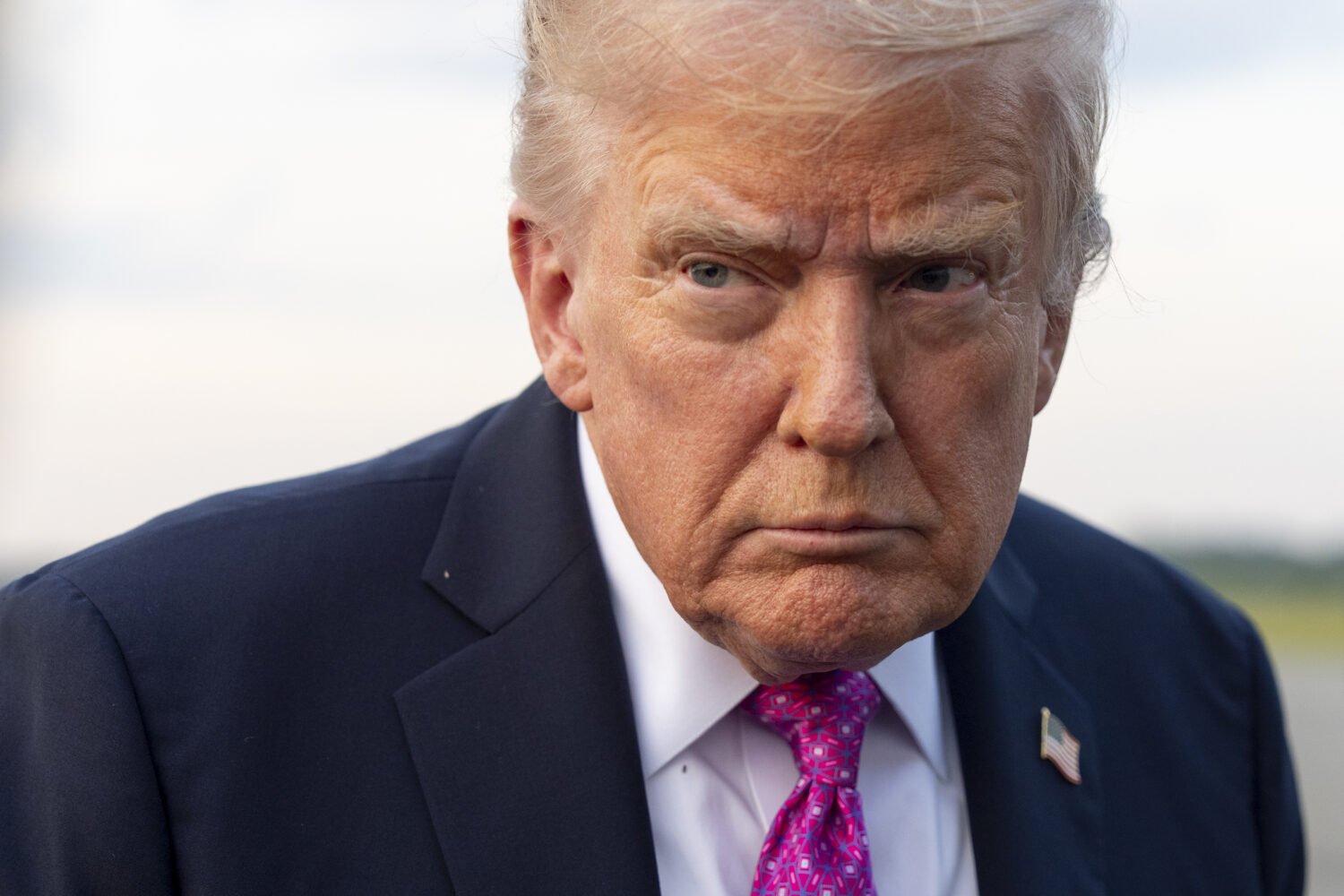 President Donald Trump speaks with reporters before he departs on Air Force One at Morristown Airpo...