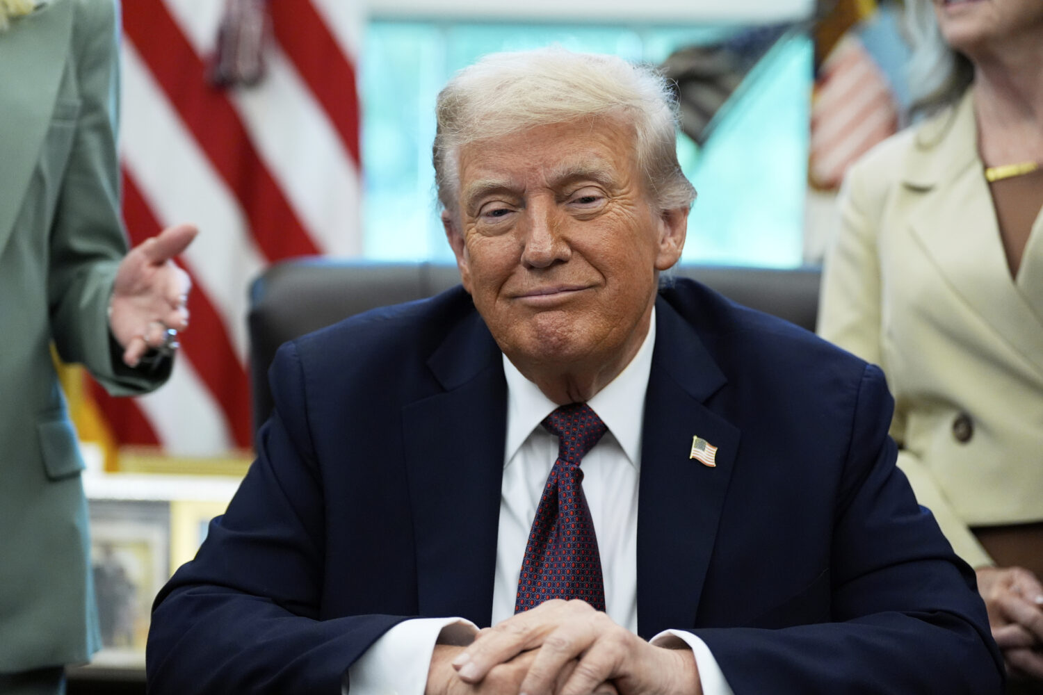 President Donald Trump listens before signing a memorandum in the Oval Office of the White House, M...