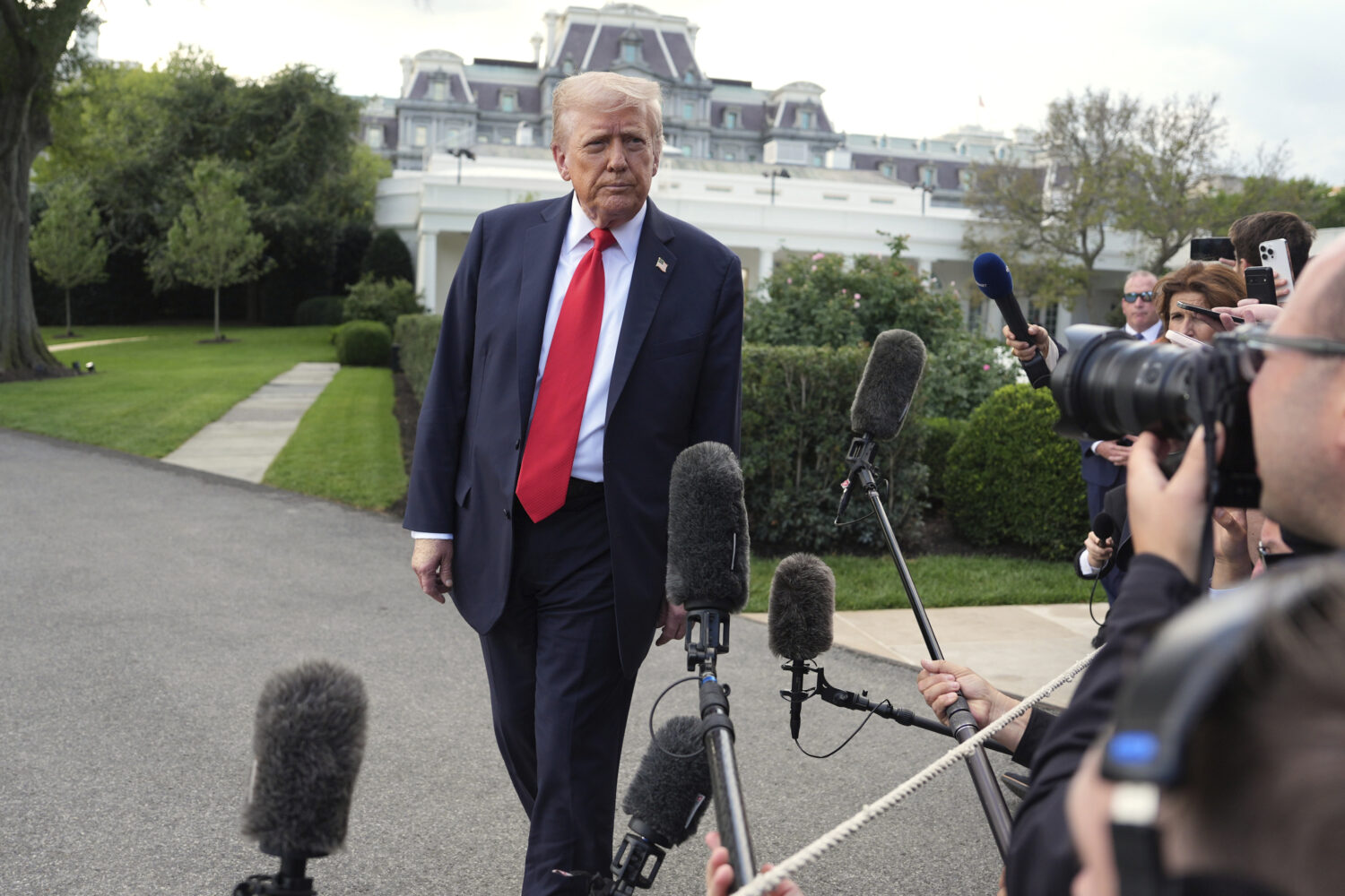 President Donald Trump speaks with reporters before boarding Marine One on the South Lawn of the Wh...