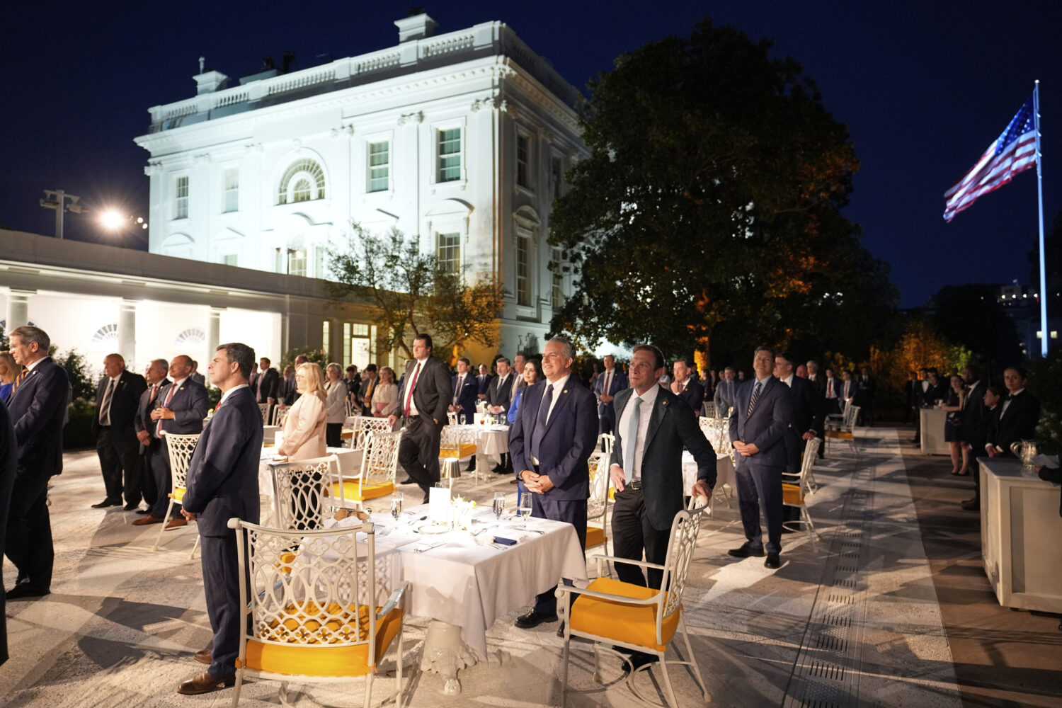 Members of Congress listen as President Donald Trump speaks at a dinner in the Rose Garden of the W...