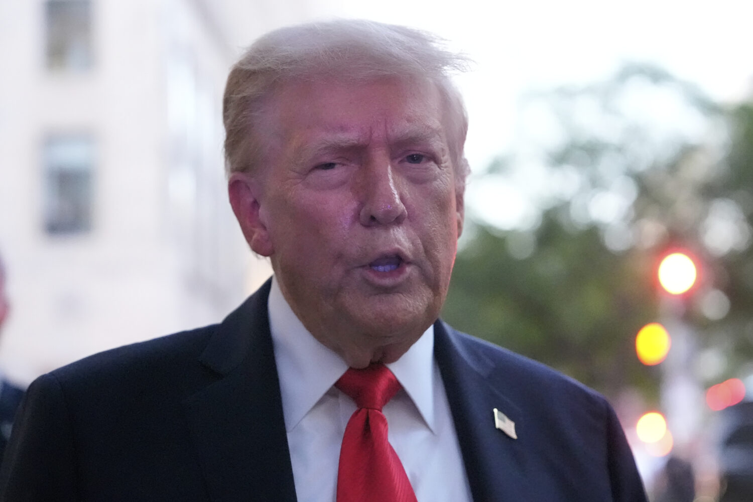 President Donald Trump speaks to reporters before he enters a restaurant near the White House, Tues...