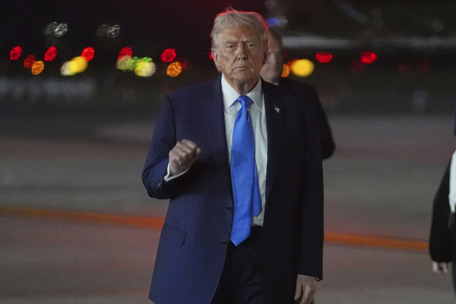 President Donald Trump gestures as he arrives on Air Force One at John F. Kennedy International Air...