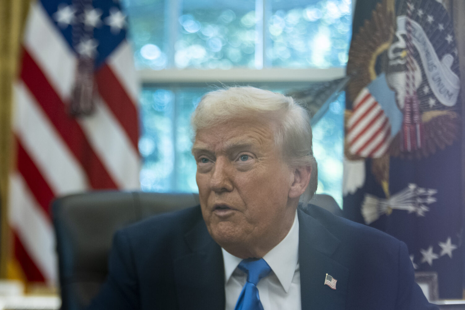 President Donald Trump speaks with reporters in the Oval Office of the White House, Friday, Sept. 1...