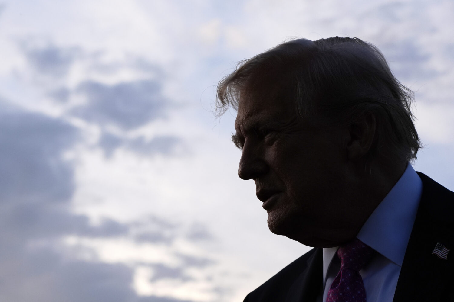 FILE - President Donald Trump speaks with reporters before boarding Air Force One at Morristown Air...