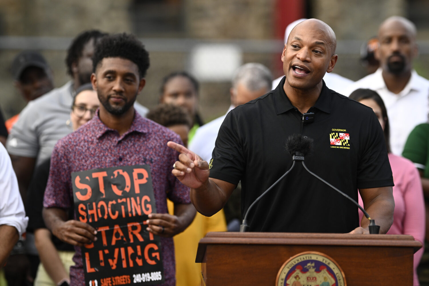 Maryland Gov. Wes Moore, right, speaks next to Baltimore mayor Brandon Scott, left, during a news c...