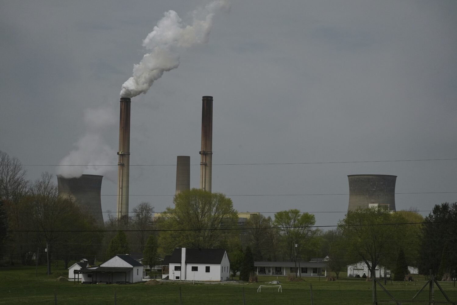 FILE - A home sits near the Gen. James Gavin Power Plant, a coal-fired power plant, April 14, 2025,...