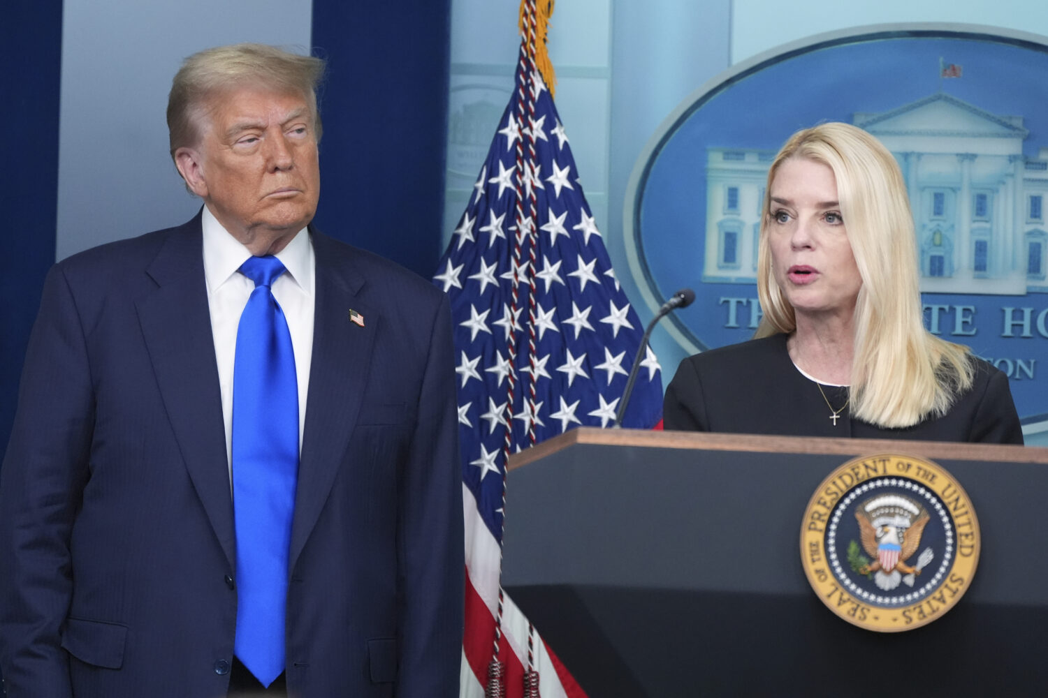 FILE - Attorney General Pam Bondi speaks to reporters as President Donald Trump listens, Friday, Ju...