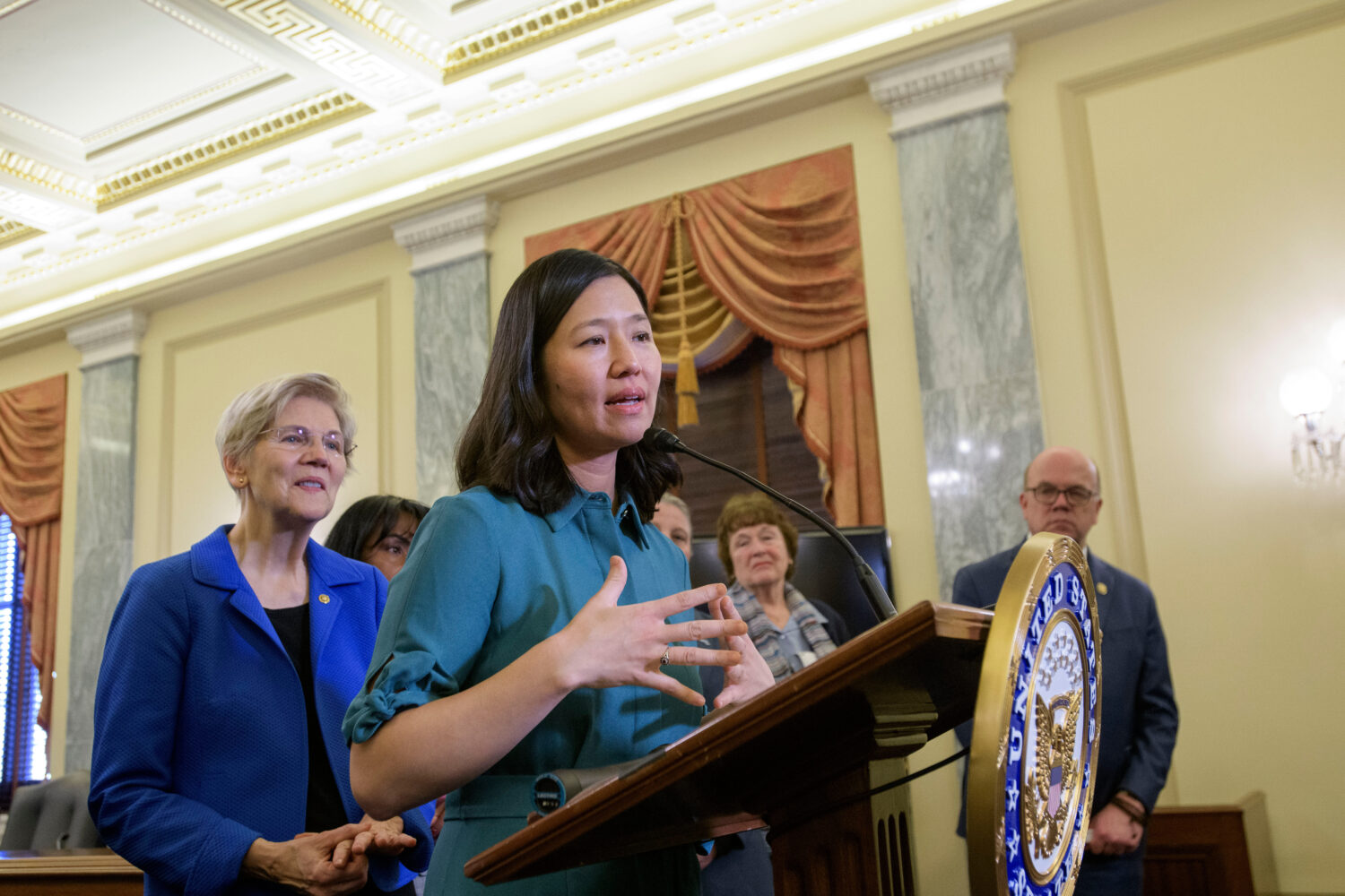 FILE - Boston Mayor Michelle Wu, right, is joined by Sen. Elizabeth Warren, D-Mass., left, as she s...