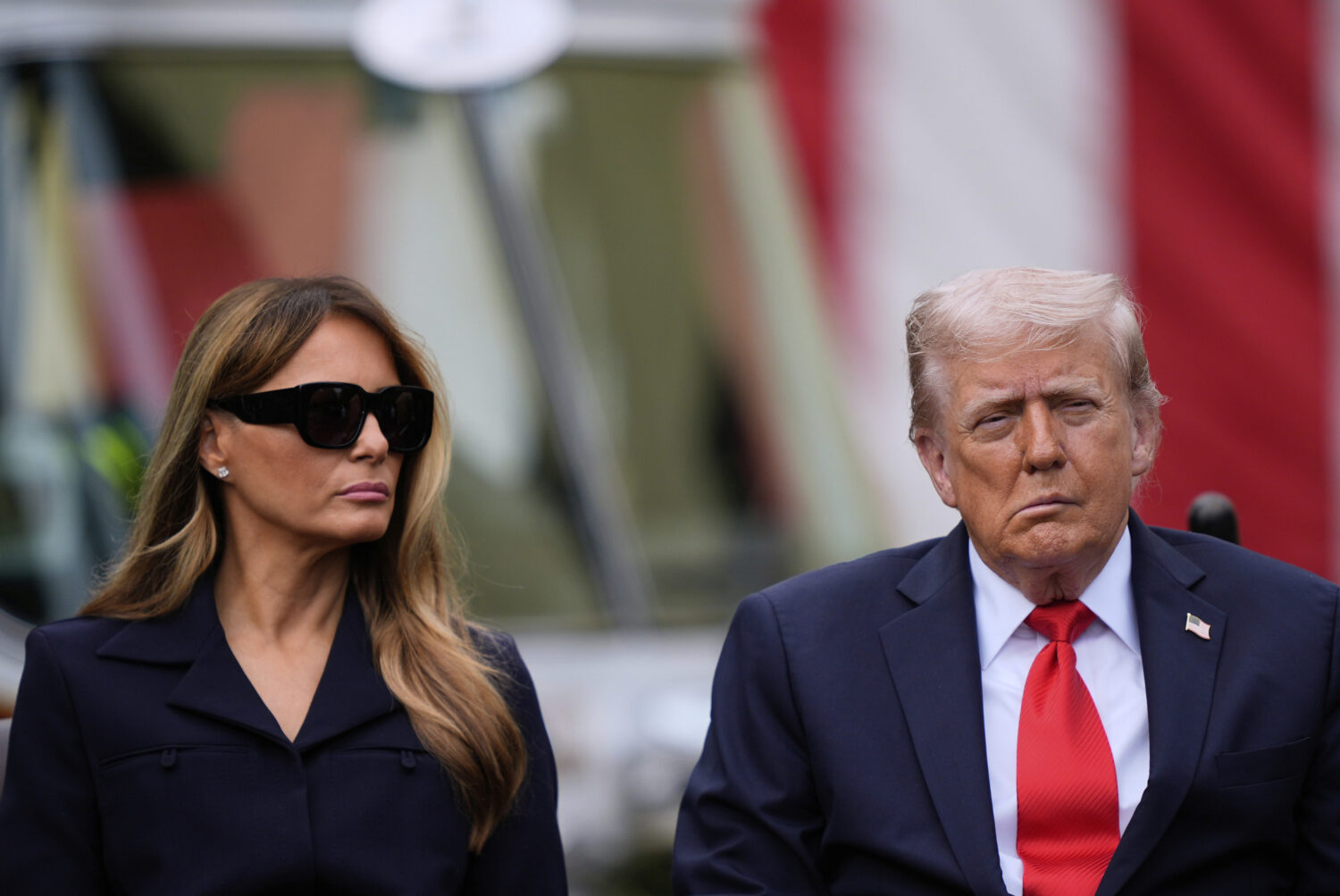 President Donald Trump and first lady Melania Trump listens as names are read as they attend a cere...