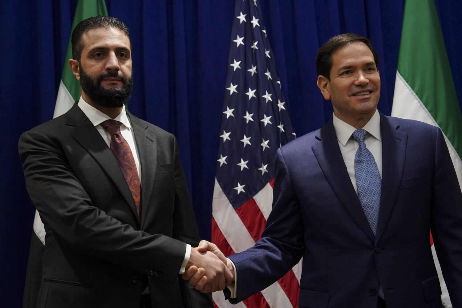 Secretary of State Marco Rubio shakes hands with Syrian interim President Ahmad al-Sharaa at the Lo...