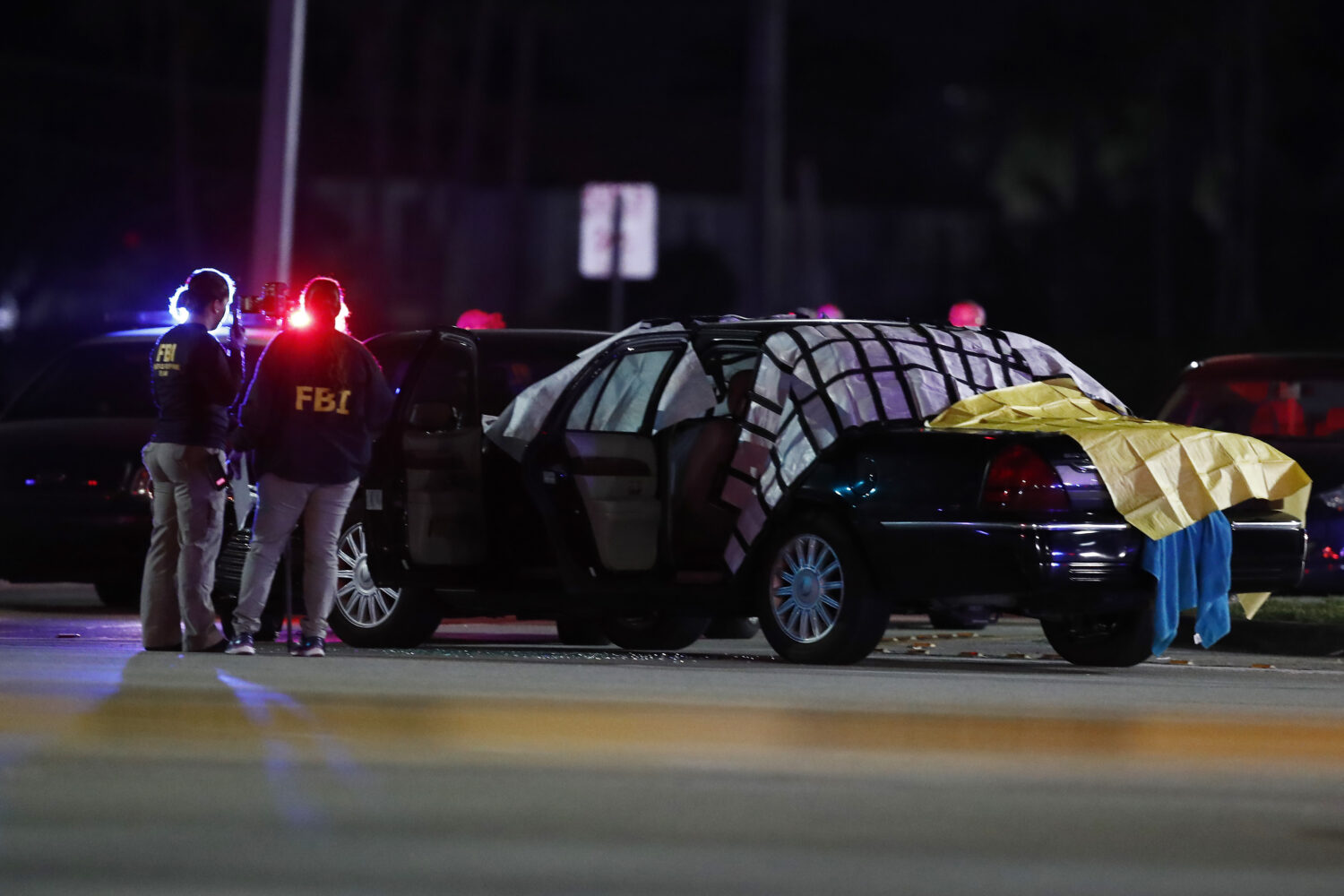 FILE - Authorities investigate the scene of a fatal shooting Dec. 5, 2019, in Miramar, Fla. (AP Pho...