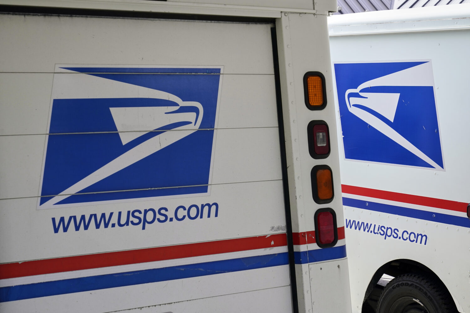 FILE - U.S. Postal Service delivery vehicles are parked outside a post office in Boys Town, Neb., A...