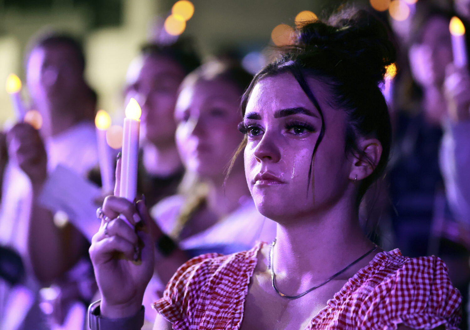 Tears stream down Alexa Maliwauki's face as she attends a Vigil for Unity at the UCCU Center at Uta...