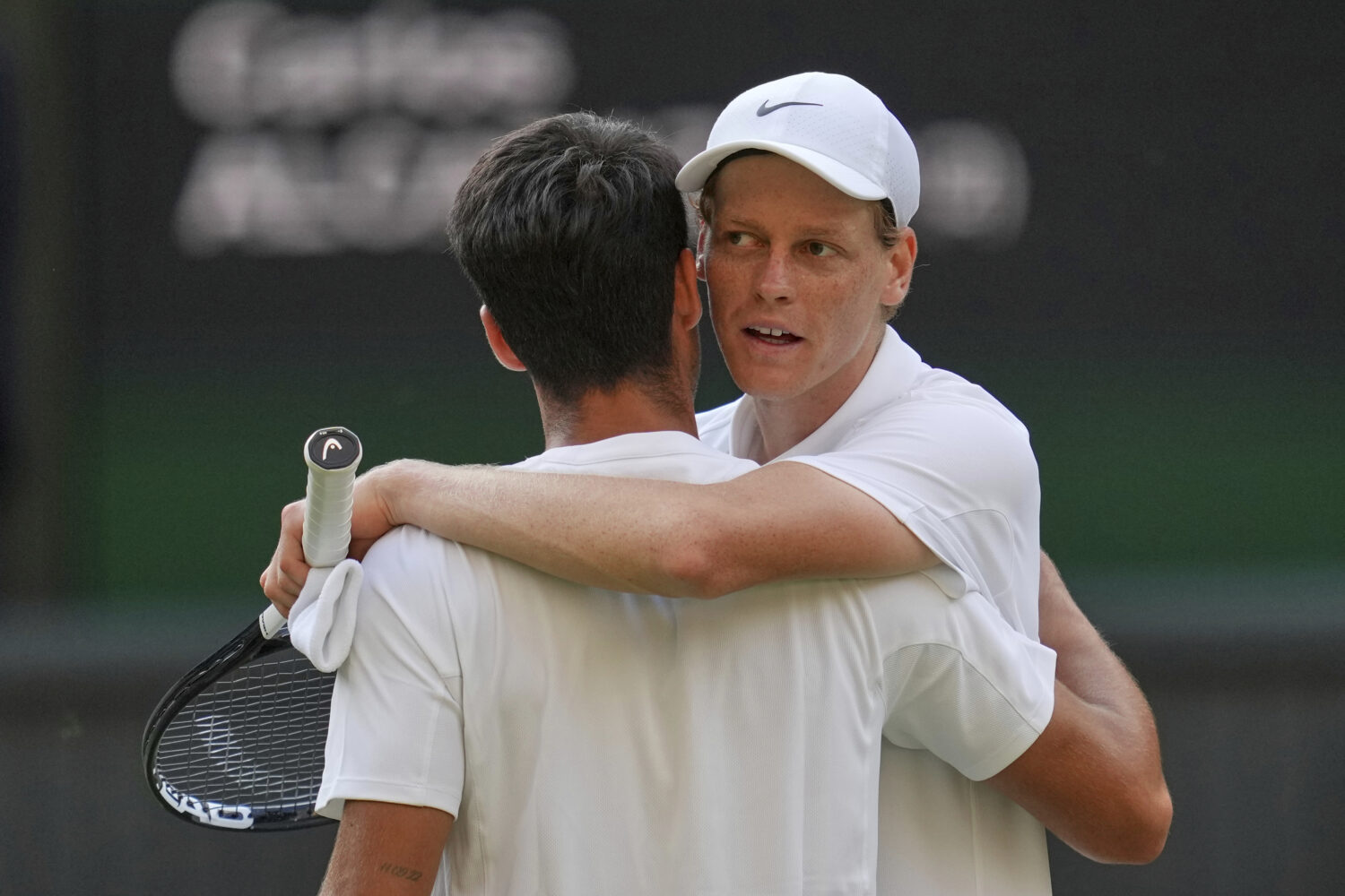 FILE - Italy's Jannik Sinner, right, greets Carlos Alcaraz, of Spain, at the net after beating him ...