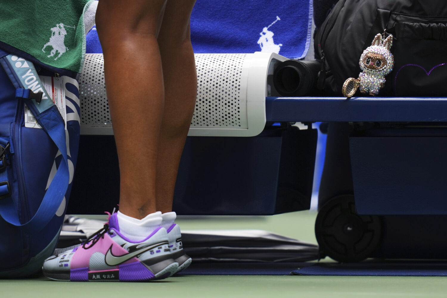 A Labubu doll sits near Naomi Osaka, of Japan, before her match against Coco Gauff, of the United S...