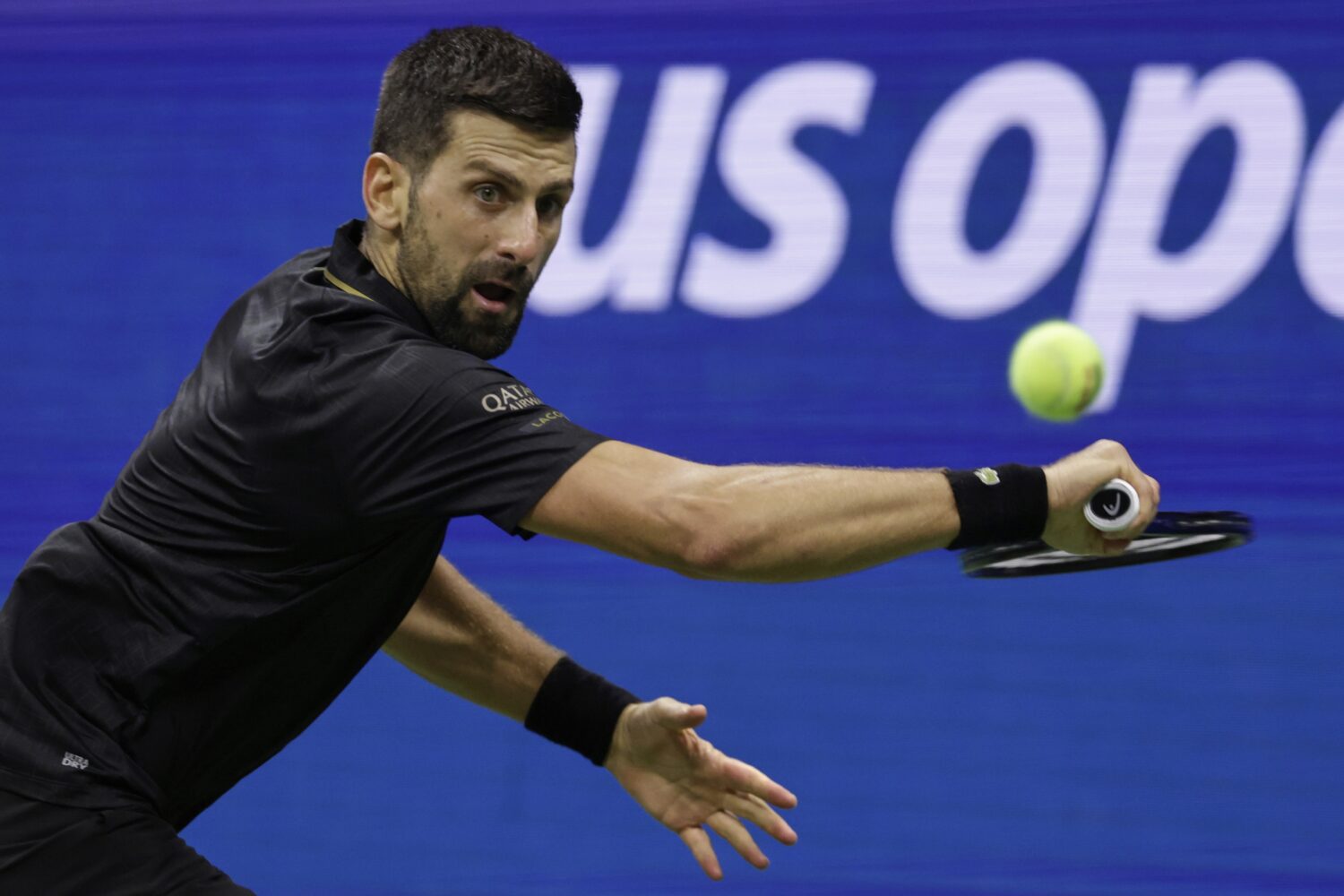 Novak Djokovic, of Serbia, returns a shot against Taylor Fritz, of the United States, during the qu...