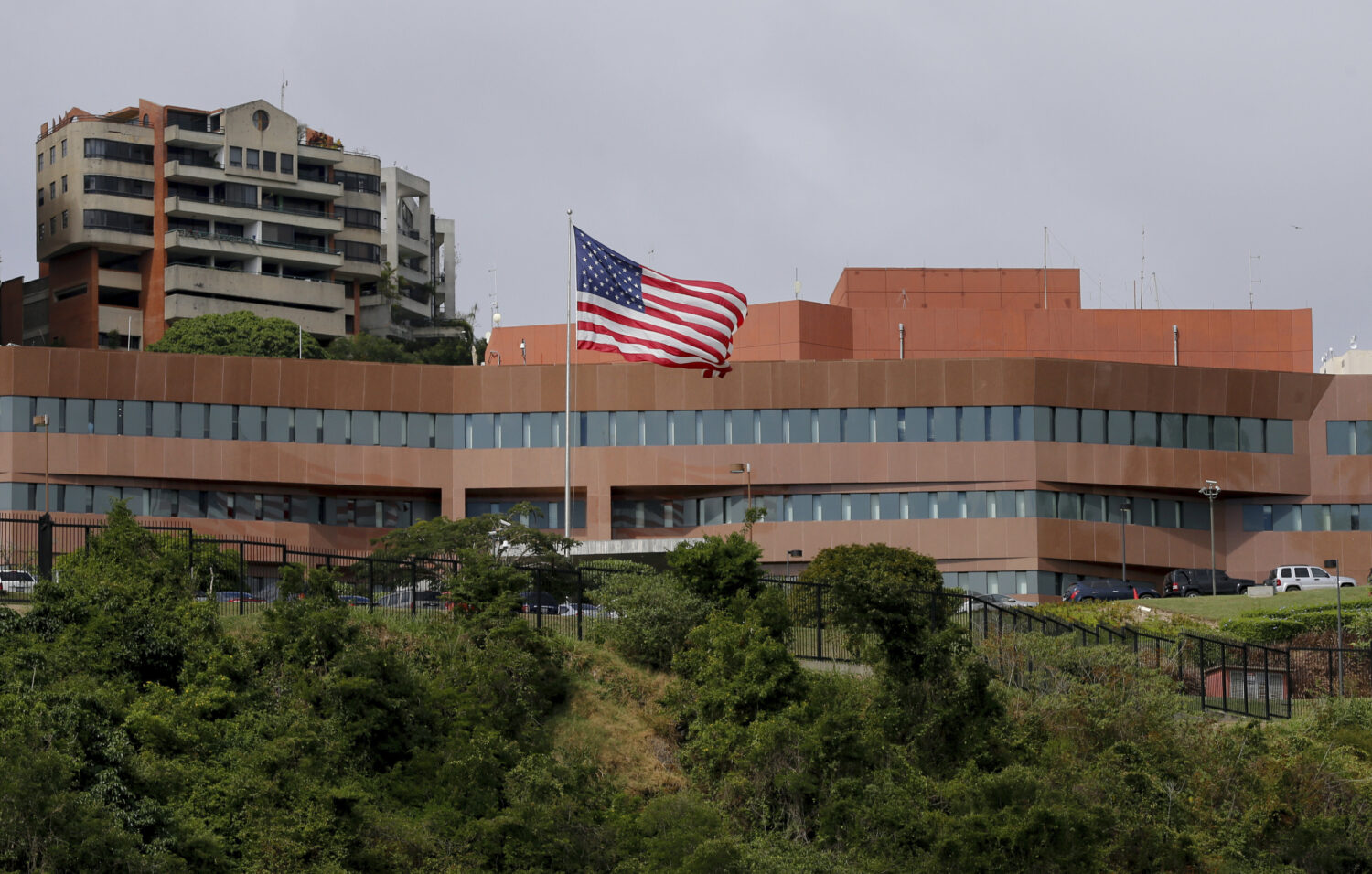 FILE - The U.S flag flies outside the U.S. embassy in Caracas, Venezuela, Jan. 24, 2019. (AP Photo/...