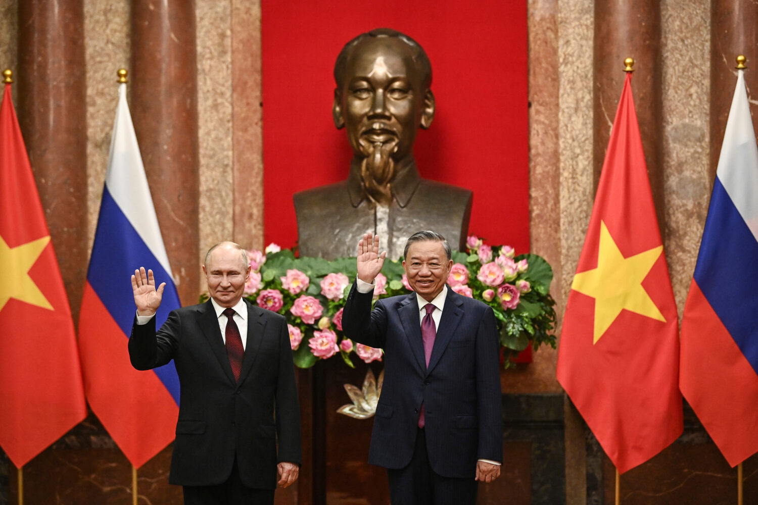 FILE - Russian President Vladimir Putin, left, and Vietnam's President To Lam pose for photos at th...