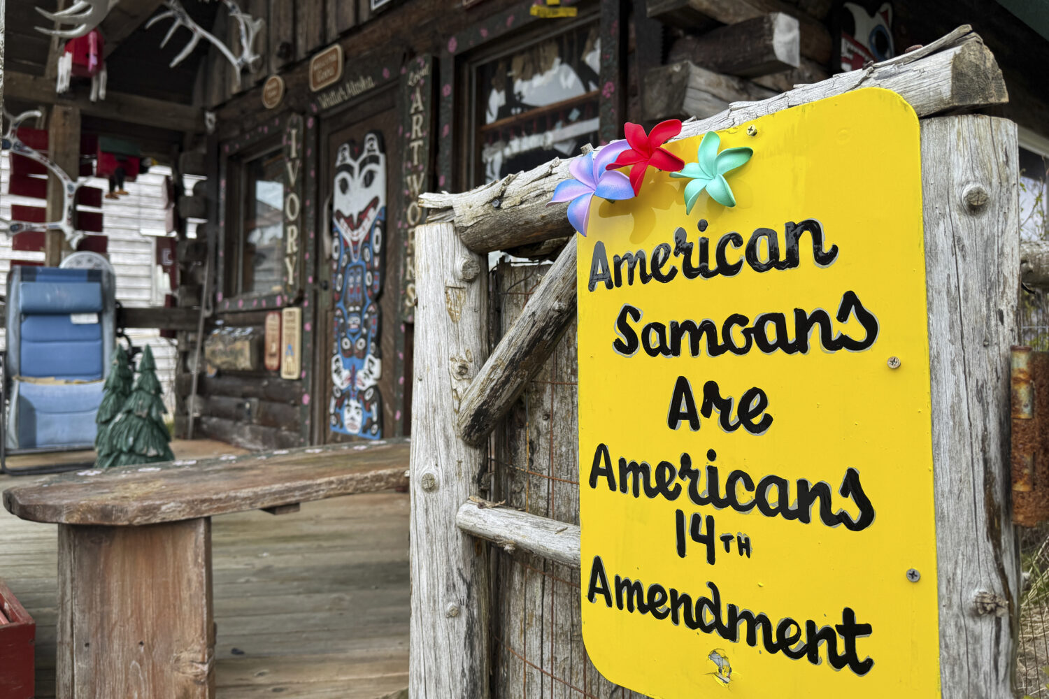 FILE - A sign supporting citizenship for American Samoans is posted outside the Log Cabin Gifts sto...
