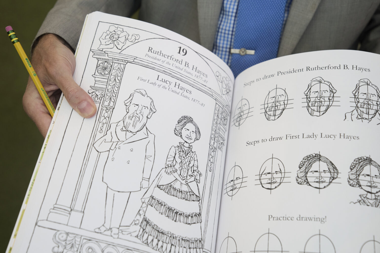 John Hutton, illustrator and professor of art history at Salem College, holds open his book, "How T...