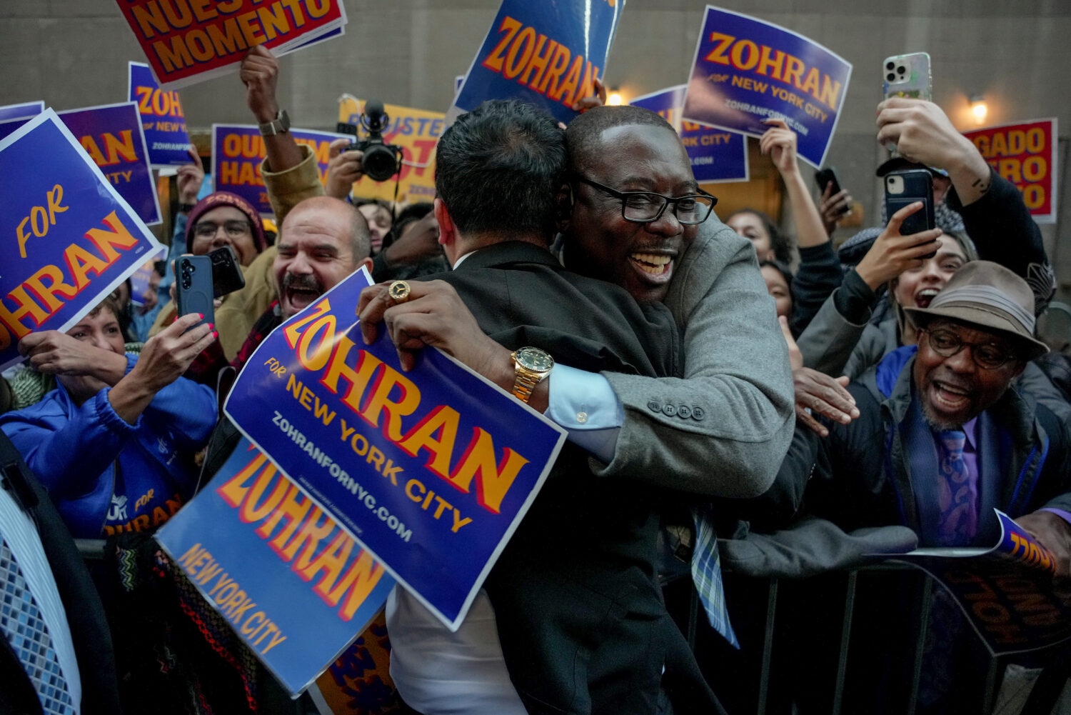 Democratic candidate Zohran Mamdani, left, greets supporters upon arriving to participate in a mayo...