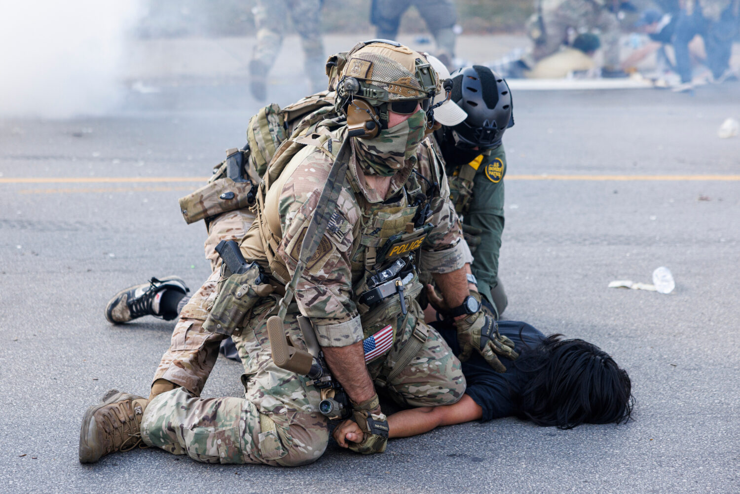 Federal officers hold down a protester in the Brighton Park neighborhood of Chicago, on Saturday, O...
