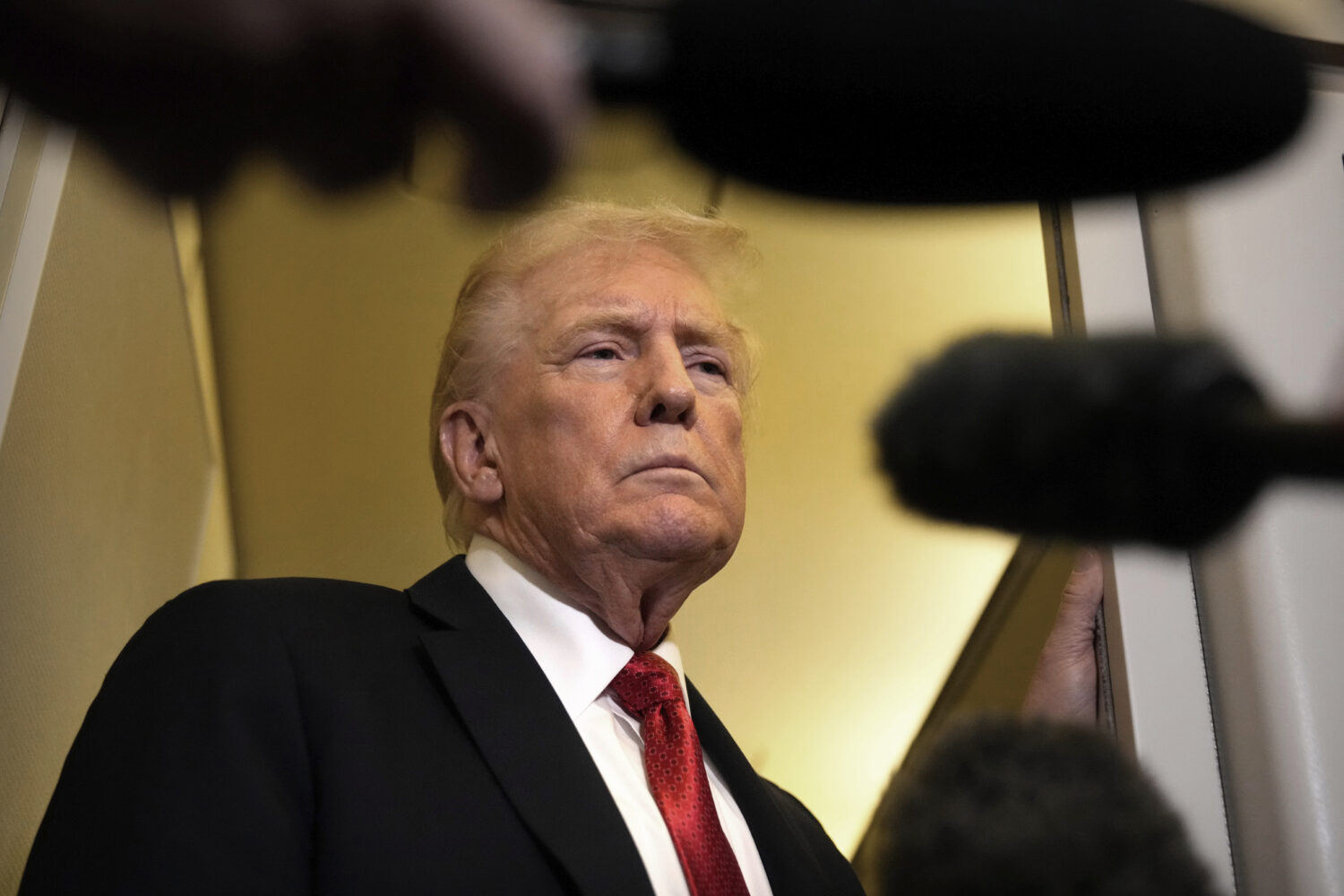 President Donald Trump speaks to reporters aboard Air Force One, Sunday, Oct. 19, 2025, en route to...