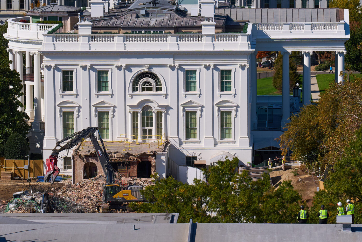 Construction workers, bottom right, atop the U.S. Treasury, watch as work continues on a largely de...