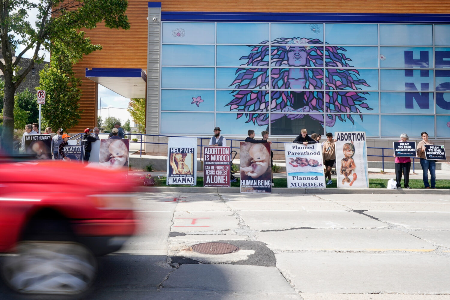 FILE - Protesters are seen outside Planned Parenthood, Sept. 18, 2023, in Milwaukee. (AP Photo/Morr...