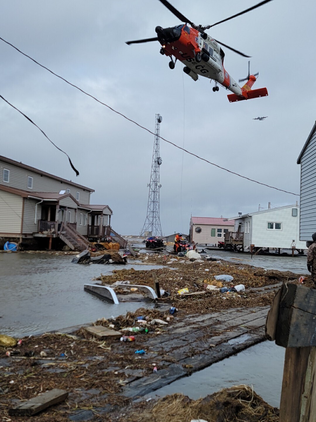 A helicopter responds after the remnant storms of Typhoon Halong devastated Kipnuk, Alaska, on Sund...