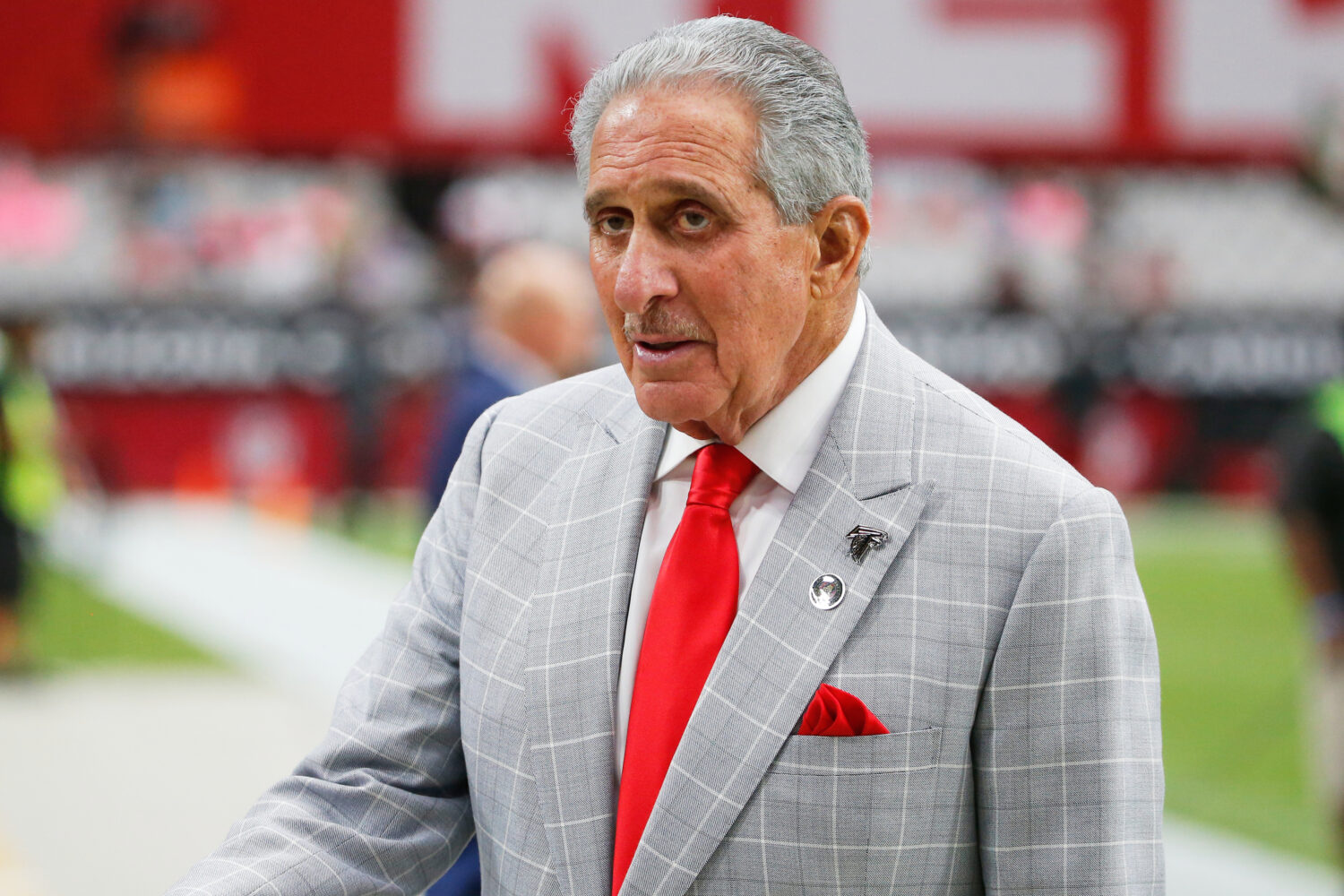FILE - Atlanta Falcons owner Arthur Blank stands on the field prior to an NFL football game against...
