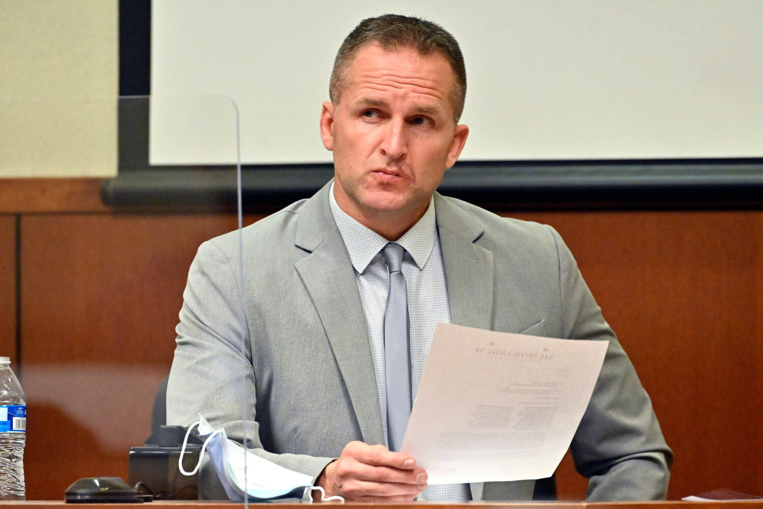FILE - Former Louisville Police officer Brett Hankison examines a document as he answers questions ...