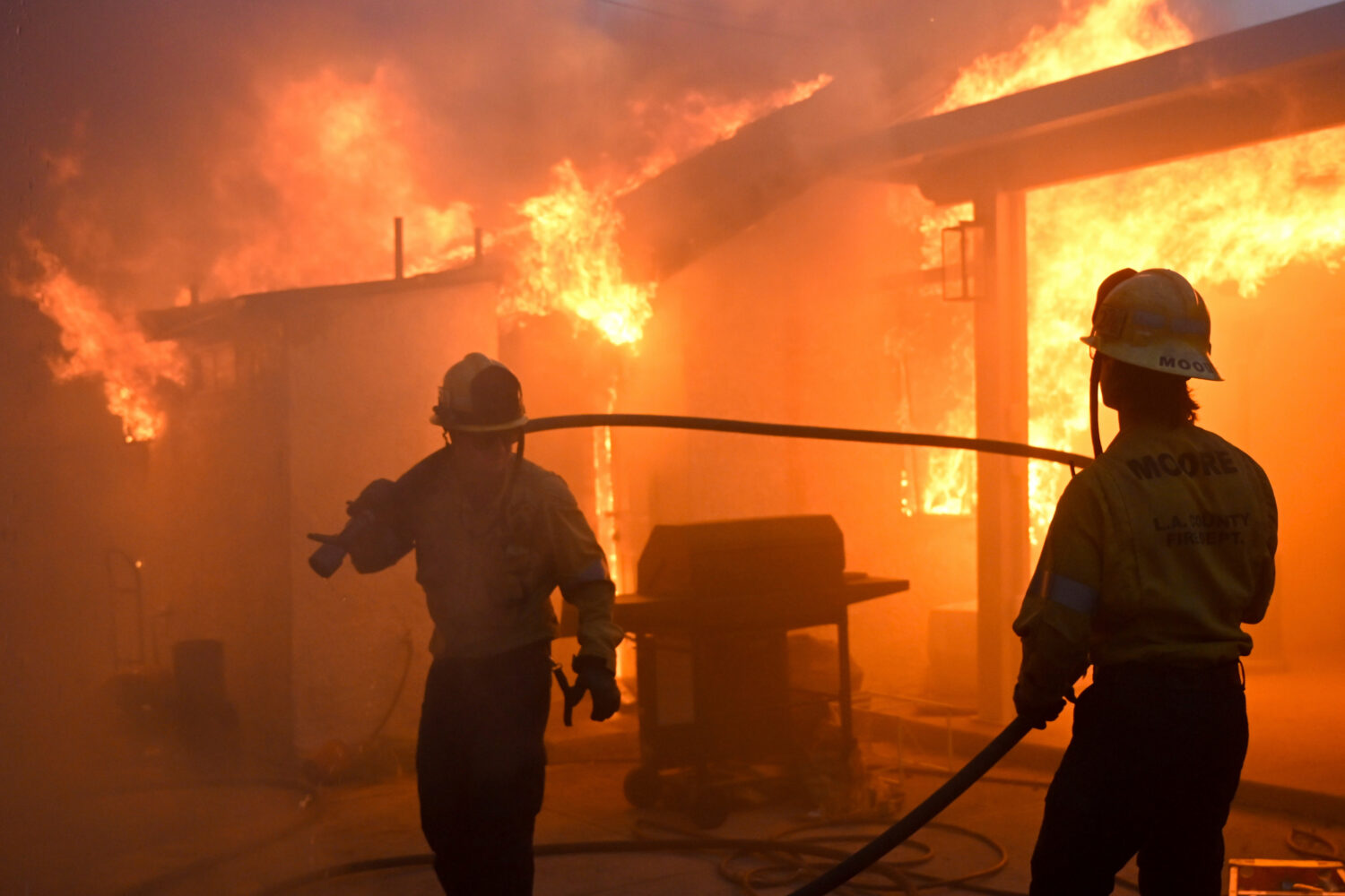 FILE - Firefighters battle the Eaton Fire as it engulfs structures, Jan. 8, 2025 in Altadena, Calif...